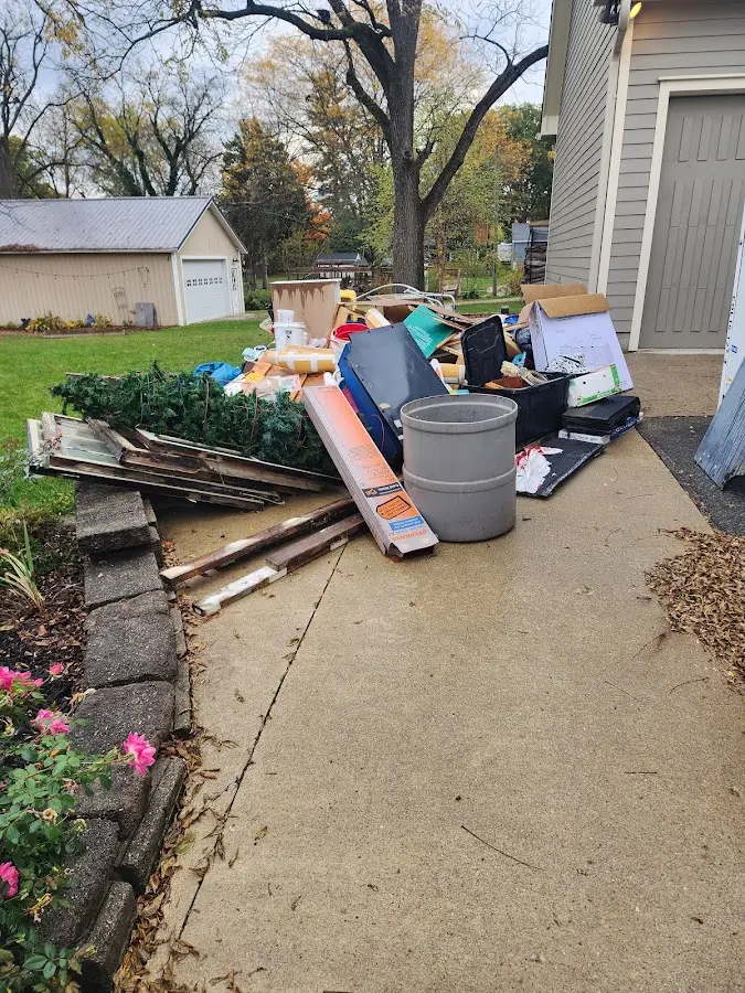 Dumpster being loaded with debris for 10 Yard Dumpster Rental in Granby
